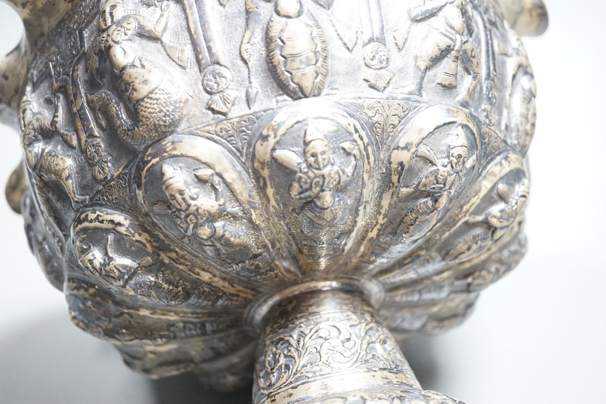 A late 19th century Burmese embossed white metal pedestal bowl, with wavy border, diameter, 27.2cm, 20.5oz.